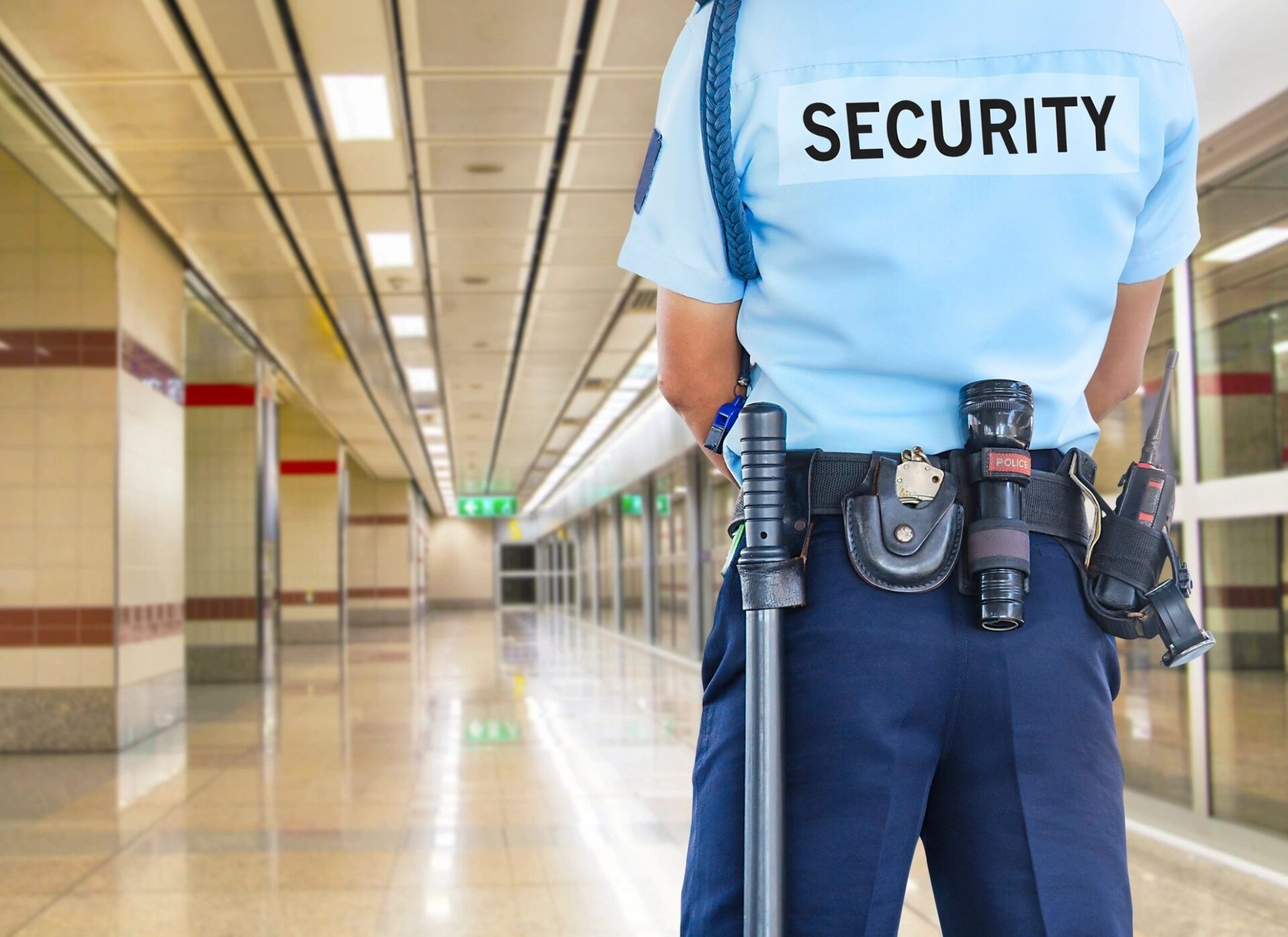 A person wearing OMEK International security blue uniform
